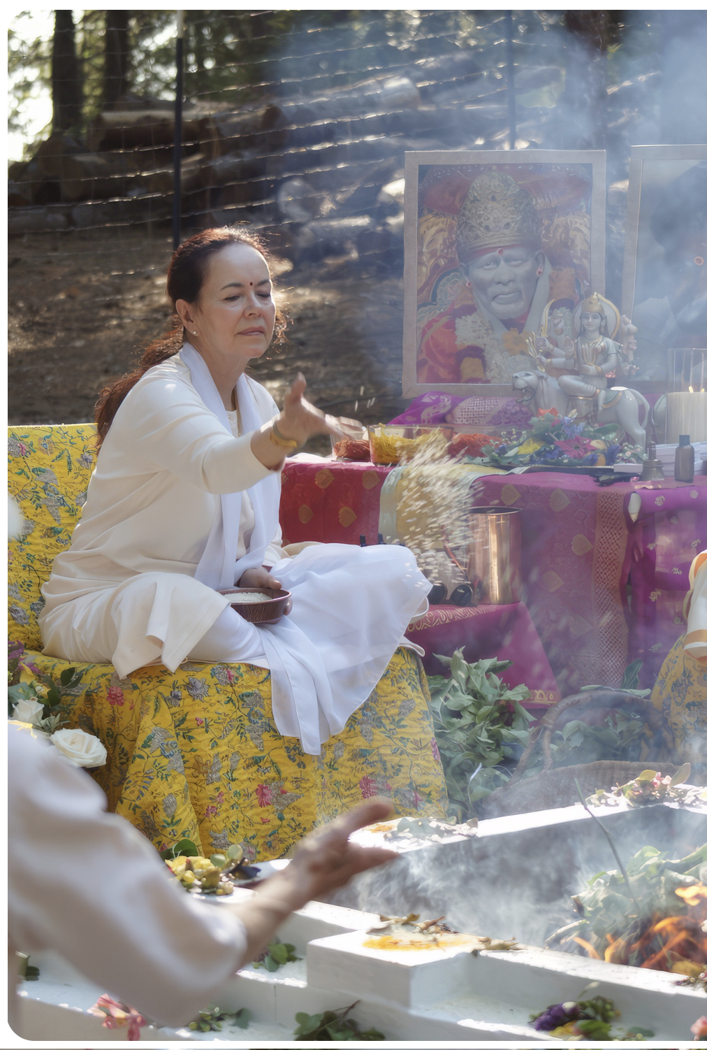 Mataji gives an offering to Mahalakshmi during the fire ceremony at the Divine Mother Center