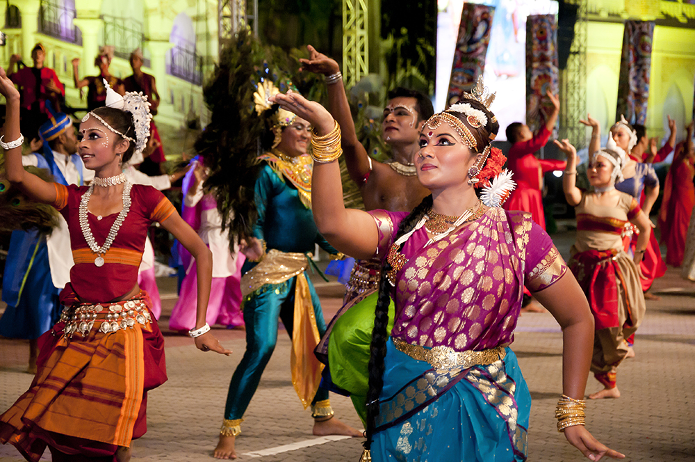 Multicultural dancers performing in a Ganesh Chaturthi celebration